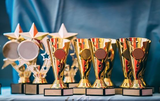 Different Champion Golden Trophy, Trophies. Winners Cups On Blue Cloth Background